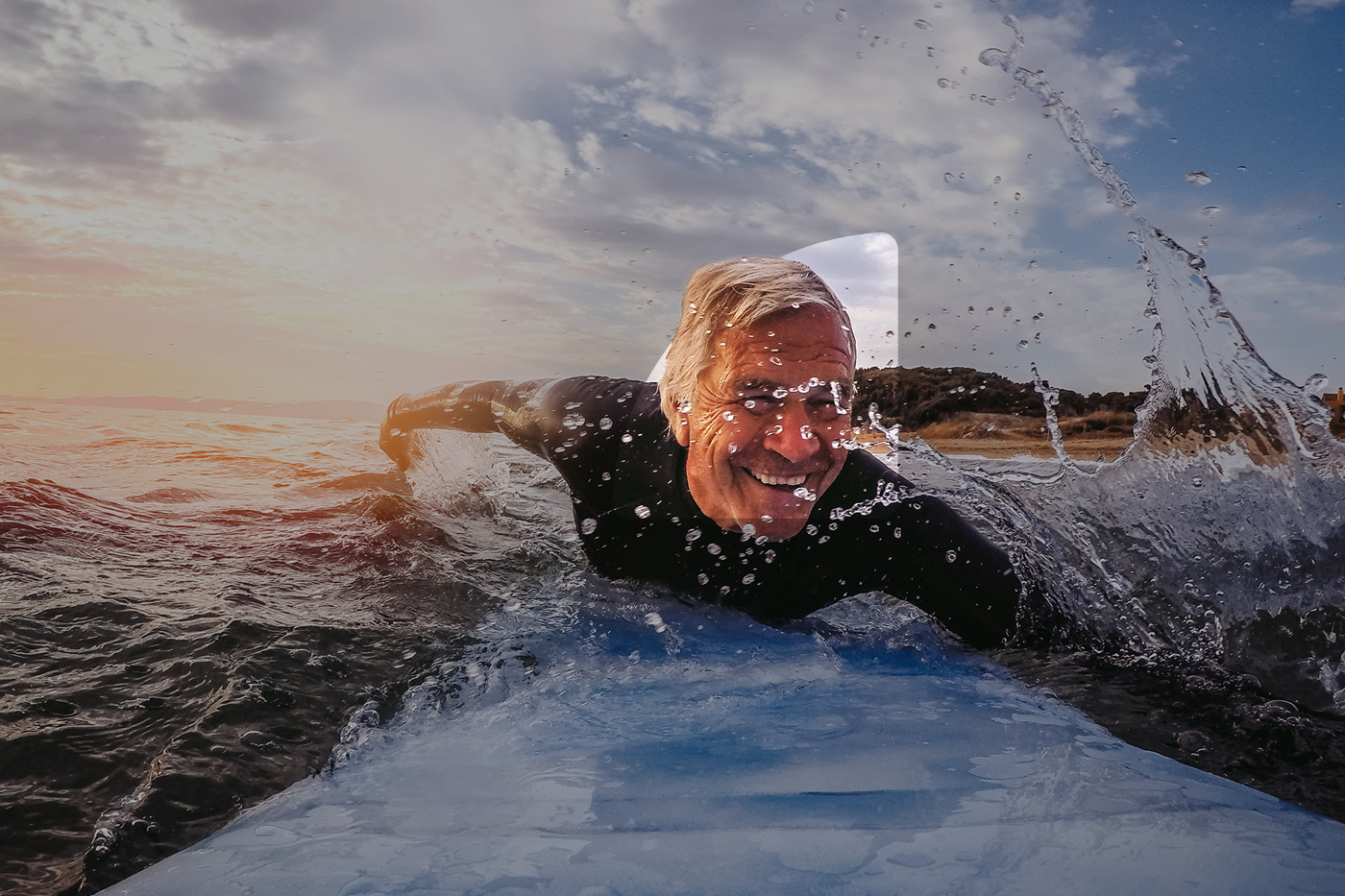 A photo of a surfer smiling. There is a mask highlighting his face with a shape of a quadrant, connecting Funding Circle's logo.